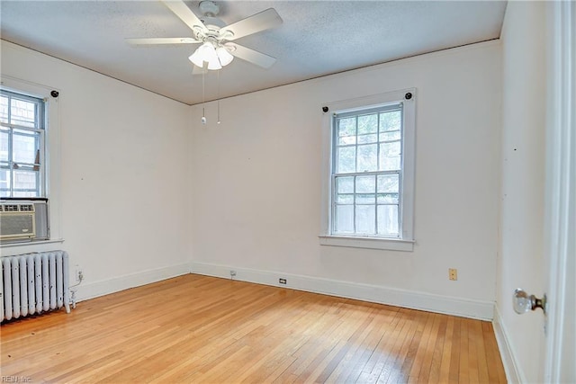 751 Shirley Ave, Norfolk, VA 23517 - unfurnished room featuring radiator heating unit, light wood finished floors, baseboards, a ceiling fan, and a textured ceiling