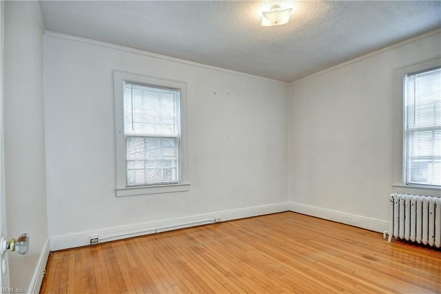 751 Shirley Ave, Norfolk, VA 23517 - empty room featuring radiator heating unit, hardwood / wood-style flooring, ornamental molding, baseboards, and a textured ceiling