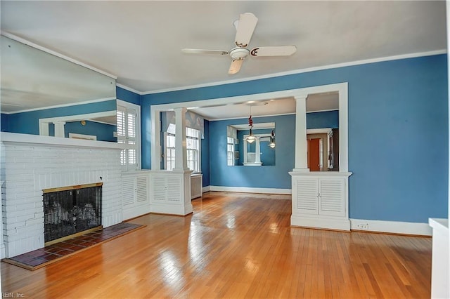 751 Shirley Ave, Norfolk, VA 23517 - unfurnished living room with baseboards, a brick fireplace, crown molding, and hardwood / wood-style flooring