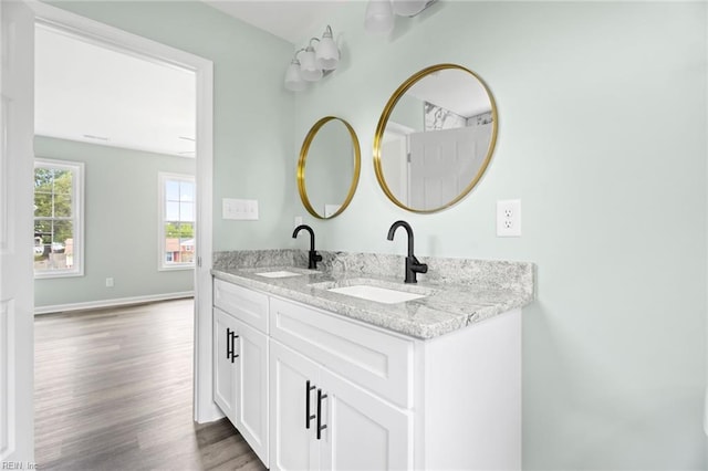 2915 Berkley Ave, Chesapeake, VA 23325 - bathroom featuring wood finished floors, double vanity, and baseboards