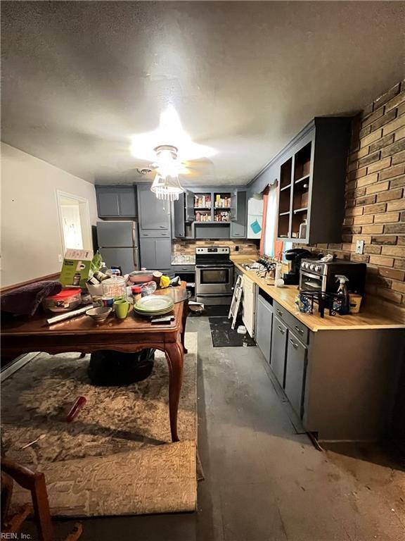 418 Fox Hill Rd, Hampton, VA 23669 - kitchen featuring freestanding refrigerator, electric range, open shelves, concrete flooring, and a ceiling fan