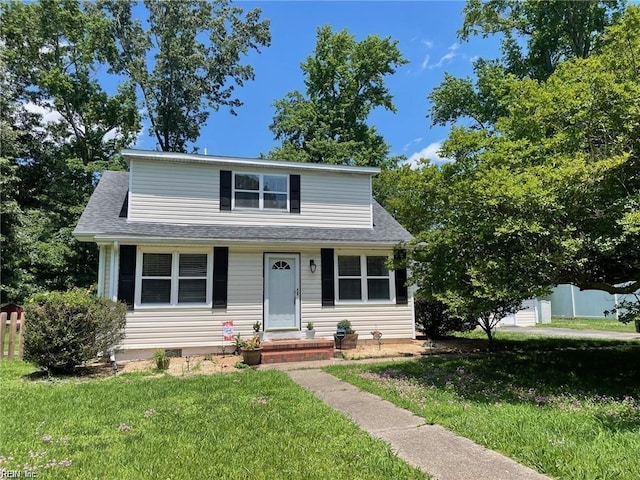 21139 Reynolds Dr, Carrollton, VA 23314 - view of front of house with a front lawn, a shingled roof, and crawl space