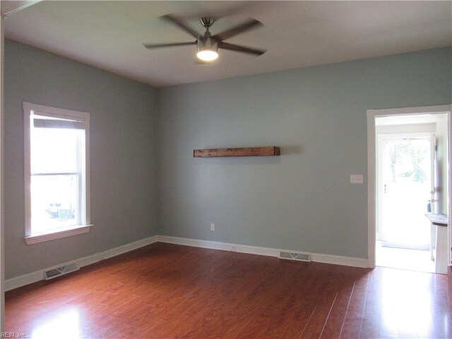 21139 Reynolds Dr, Carrollton, VA 23314 - spare room featuring a ceiling fan, wood finished floors, and baseboards