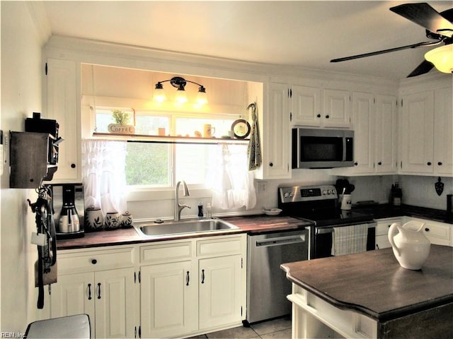 21139 Reynolds Dr, Carrollton, VA 23314 - kitchen featuring appliances with stainless steel finishes, a sink, ceiling fan, and white cabinetry