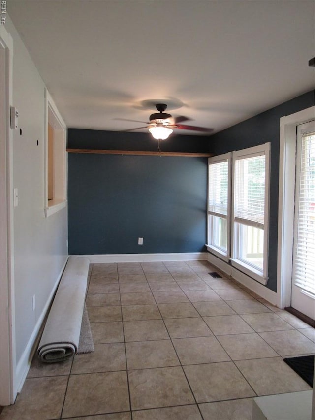 21139 Reynolds Dr, Carrollton, VA 23314 - unfurnished room featuring ceiling fan, plenty of natural light, light tile patterned flooring, and baseboards