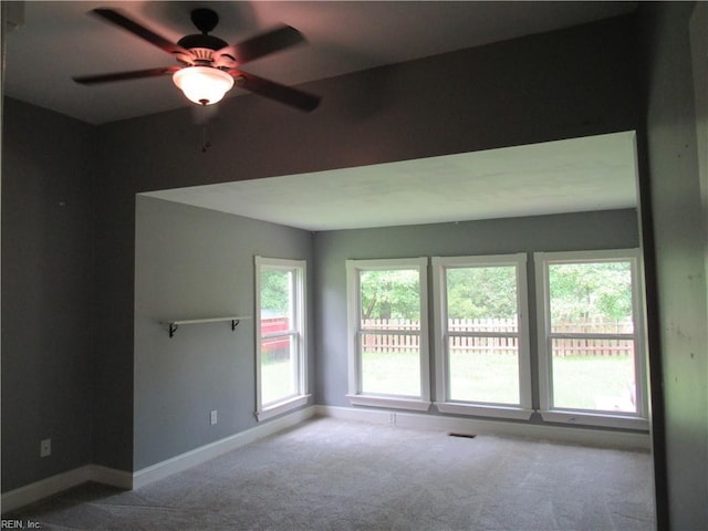 21139 Reynolds Dr, Carrollton, VA 23314 - spare room with carpet floors, a ceiling fan, and baseboards