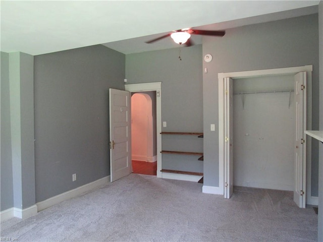 21139 Reynolds Dr, Carrollton, VA 23314 - unfurnished bedroom with carpet flooring, a closet, arched walkways, ceiling fan, and baseboards