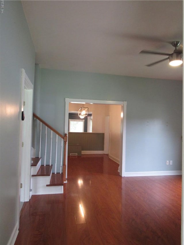 21139 Reynolds Dr, Carrollton, VA 23314 - corridor featuring stairs, wood finished floors, and baseboards