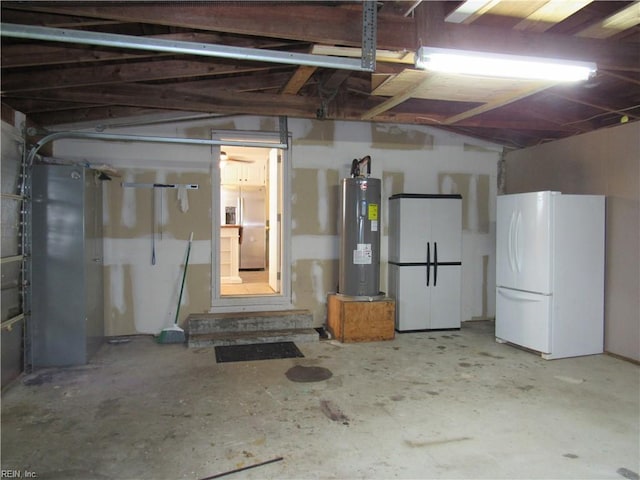 21139 Reynolds Dr, Carrollton, VA 23314 - garage featuring freestanding refrigerator and electric water heater