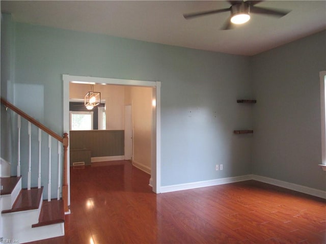 21139 Reynolds Dr, Carrollton, VA 23314 - spare room featuring a ceiling fan, wood finished floors, stairs, and baseboards