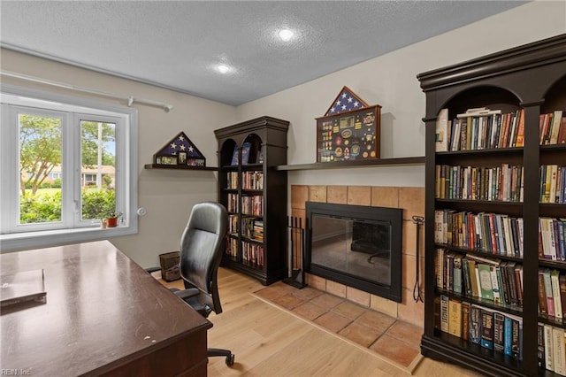5409 Challedon Dr, Virginia Beach, VA 23462 - office with a textured ceiling, a tiled fireplace, and wood finished floors
