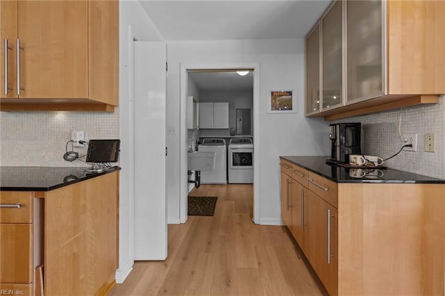 5409 Challedon Dr, Virginia Beach, VA 23462 - kitchen featuring washing machine and dryer, dark countertops, light wood finished floors, and tasteful backsplash