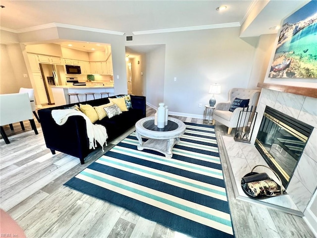 30 Brough Ln # 301, Hampton, VA 23669 - living room featuring light wood-style flooring, crown molding, baseboards, recessed lighting, and a high end fireplace