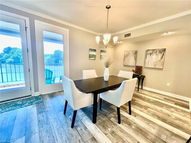 30 Brough Ln # 301, Hampton, VA 23669 - dining area featuring a chandelier, light wood-style flooring, baseboards, and crown molding