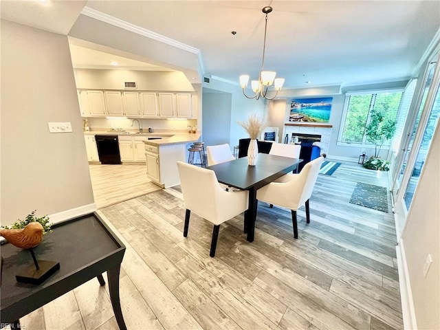 30 Brough Ln # 301, Hampton, VA 23669 - dining room with light wood-type flooring, a fireplace, a chandelier, ornamental molding, and baseboards