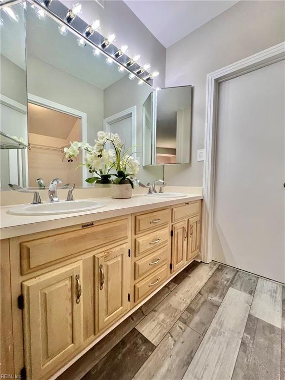 30 Brough Ln # 301, Hampton, VA 23669 - full bathroom with double vanity and wood finished floors