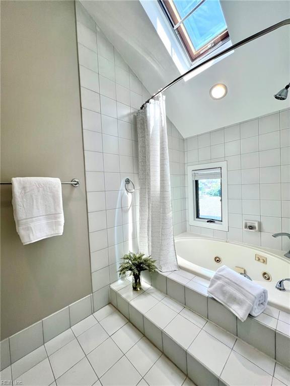 30 Brough Ln # 301, Hampton, VA 23669 - bathroom featuring a skylight, a combined bath / shower with jetted tub, tile patterned floors, vaulted ceiling, and recessed lighting