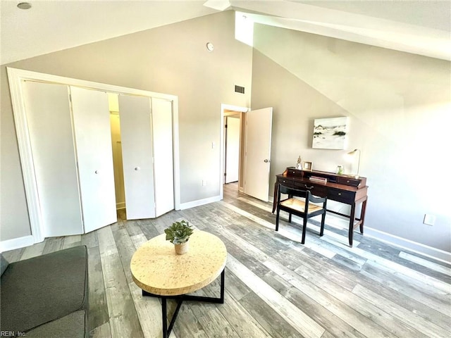 30 Brough Ln # 301, Hampton, VA 23669 - living area featuring light wood-style flooring, baseboards, and high vaulted ceiling