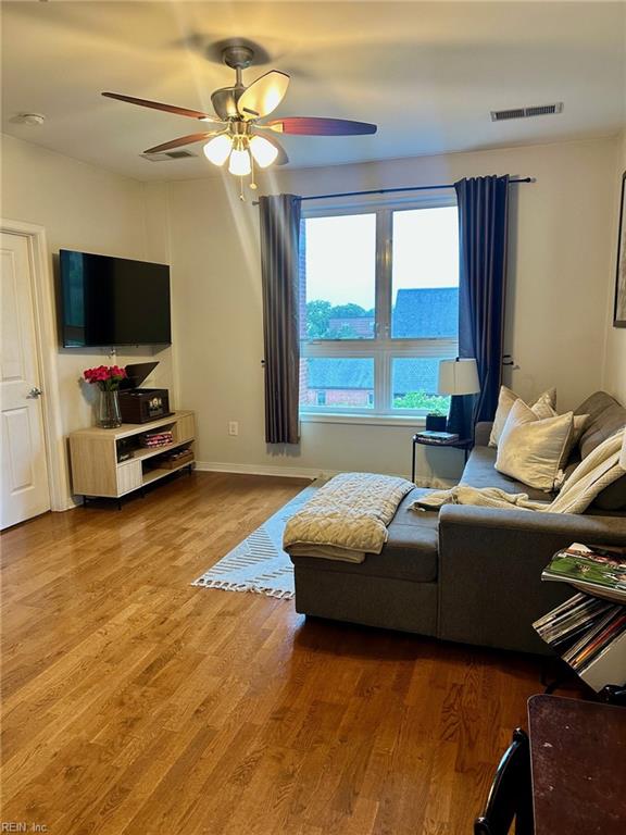 388 Boush St Unit 307, Norfolk, VA 23510 - living room featuring a ceiling fan, wood finished floors, and baseboards