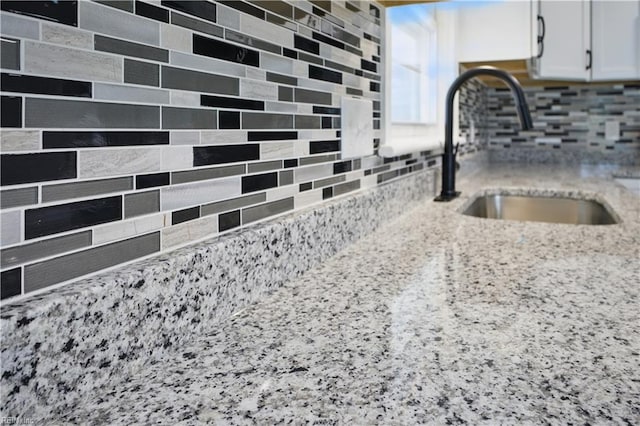 808 Williams Ave, Chesapeake, VA 23323 - kitchen view of a sink, tasteful backsplash, white cabinets, and light stone counters