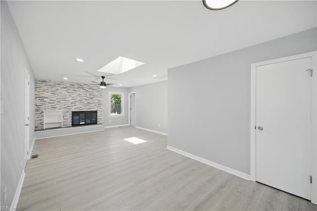 808 Williams Ave, Chesapeake, VA 23323 - unfurnished living room with a skylight, baseboards, a large fireplace, light wood-style flooring, and recessed lighting