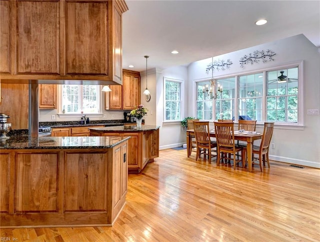 2081 Harpers Ml, Williamsburg, VA 23185 - kitchen with brown cabinetry, a peninsula, healthy amount of natural light, baseboards, and recessed lighting