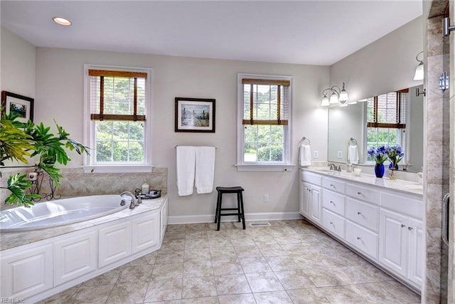 2081 Harpers Ml, Williamsburg, VA 23185 - full bathroom featuring double vanity, plenty of natural light, a bath, baseboards, and recessed lighting