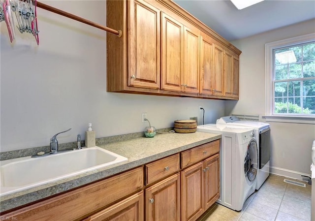 2081 Harpers Ml, Williamsburg, VA 23185 - laundry room featuring cabinet space, washer and clothes dryer, light tile patterned floors, and baseboards
