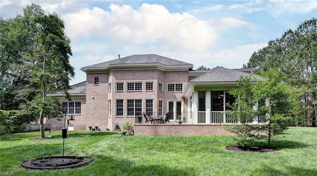 2081 Harpers Ml, Williamsburg, VA 23185 - back of house with a lawn, brick siding, a sunroom, and a patio