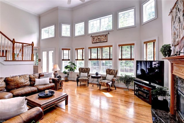 2081 Harpers Ml, Williamsburg, VA 23185 - living area with plenty of natural light, a fireplace, a towering ceiling, ornamental molding, and stairway