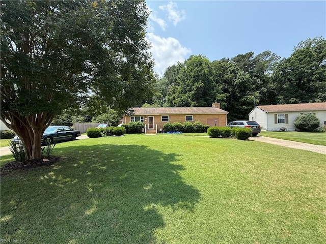 107 Carver Pl, Yorktown, VA 23692 - ranch-style house with concrete driveway, a chimney, and brick siding