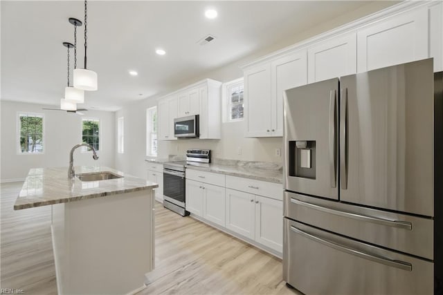 1245 Maltby Ave, Norfolk, VA 23504 - kitchen with appliances with stainless steel finishes, a sink, white cabinets, a center island with sink, and light wood-type flooring