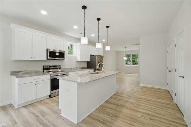 1245 Maltby Ave, Norfolk, VA 23504 - kitchen with stainless steel appliances, a sink, a kitchen island with sink, white cabinetry, and light wood-type flooring