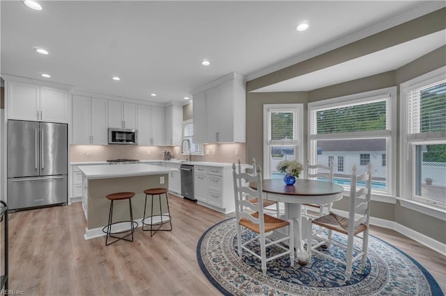 136 Wynnwood Dr, Franklin, VA 23851 - kitchen featuring stainless steel appliances, a kitchen island, white cabinetry, light countertops, and recessed lighting