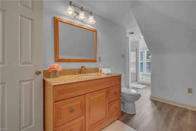 136 Wynnwood Dr, Franklin, VA 23851 - bathroom featuring toilet, vanity, wood finished floors, and baseboards