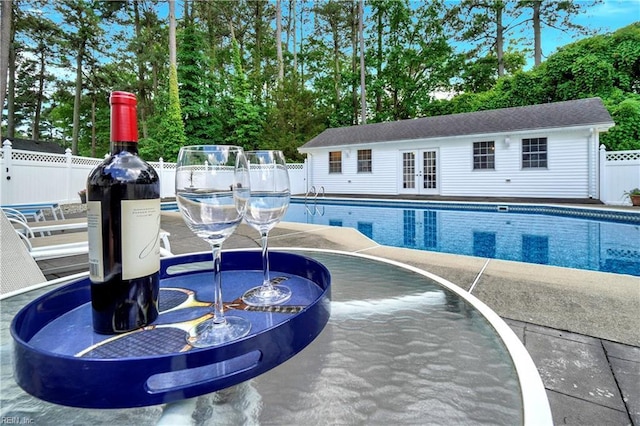 136 Wynnwood Dr, Franklin, VA 23851 - view of swimming pool featuring a fenced backyard, french doors, a patio, an outdoor structure, and view of wooded area