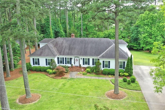 136 Wynnwood Dr, Franklin, VA 23851 - view of front facade featuring a front lawn, driveway, and a chimney