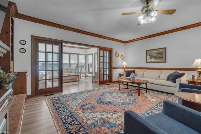 136 Wynnwood Dr, Franklin, VA 23851 - living room featuring crown molding, wood finished floors, a ceiling fan, french doors, and baseboards