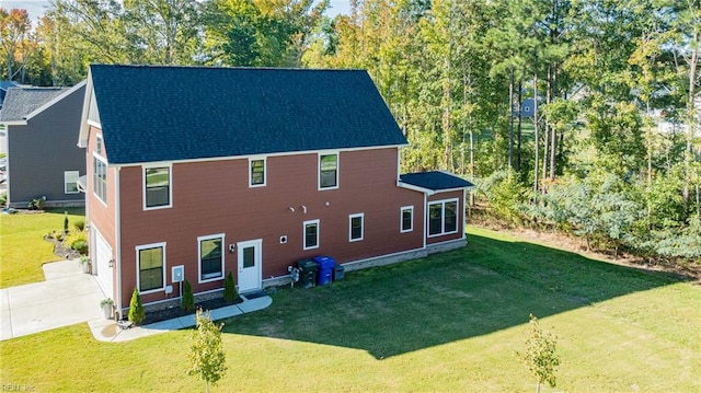 126 Secretariat Dr, Suffolk, VA 23435 - rear view of house featuring driveway, a lawn, and an attached garage