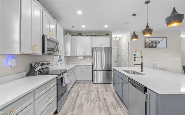126 Secretariat Dr, Suffolk, VA 23435 - kitchen with appliances with stainless steel finishes, a sink, hanging light fixtures, white cabinets, and recessed lighting