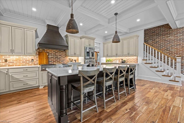 107 Gullane, Smithfield, VA 23430 - kitchen featuring custom range hood, cream cabinets, light wood-type flooring, beam ceiling, and a breakfast bar area