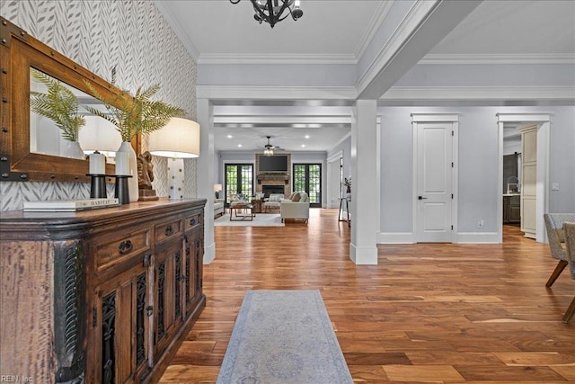 107 Gullane, Smithfield, VA 23430 - foyer with wallpapered walls, wood finished floors, baseboards, a fireplace, and crown molding