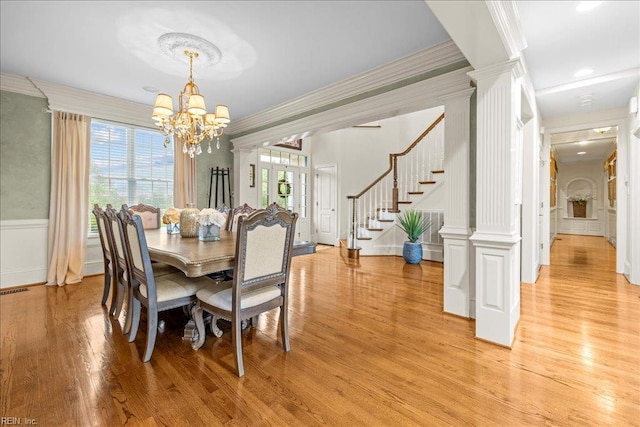 201 Royal Dornoch, Smithfield, VA 23430 - dining space with ornate columns, crown molding, stairs, a chandelier, and light wood-style floors