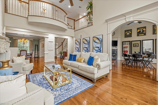 201 Royal Dornoch, Smithfield, VA 23430 - living area featuring arched walkways, a high ceiling, wood finished floors, ceiling fan, and a chandelier