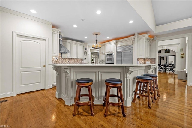 201 Royal Dornoch, Smithfield, VA 23430 - kitchen featuring stainless steel appliances, decorative backsplash, light countertops, a kitchen breakfast bar, and recessed lighting