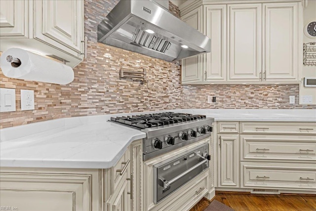 201 Royal Dornoch, Smithfield, VA 23430 - kitchen featuring wall chimney exhaust hood, stainless steel gas cooktop, cream cabinets, and a warming drawer