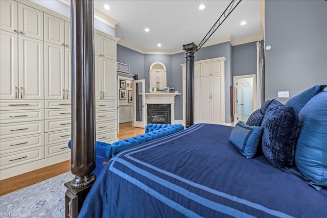 201 Royal Dornoch, Smithfield, VA 23430 - bedroom featuring crown molding, light wood-type flooring, recessed lighting, a fireplace, and ensuite bath