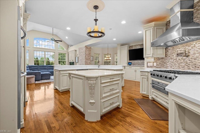 201 Royal Dornoch, Smithfield, VA 23430 - kitchen featuring wall chimney range hood, decorative light fixtures, open floor plan, a ceiling fan, and tasteful backsplash