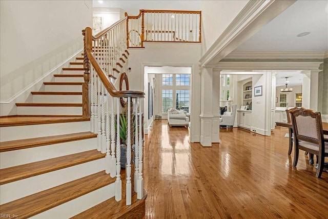 201 Royal Dornoch, Smithfield, VA 23430 - stairway with decorative columns, wood finished floors, ornamental molding, and a high ceiling