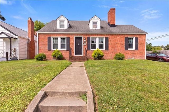 133 Chesterfield Rd, Hampton, VA 23661 - cape cod house with brick siding, a front lawn, a chimney, and entry steps